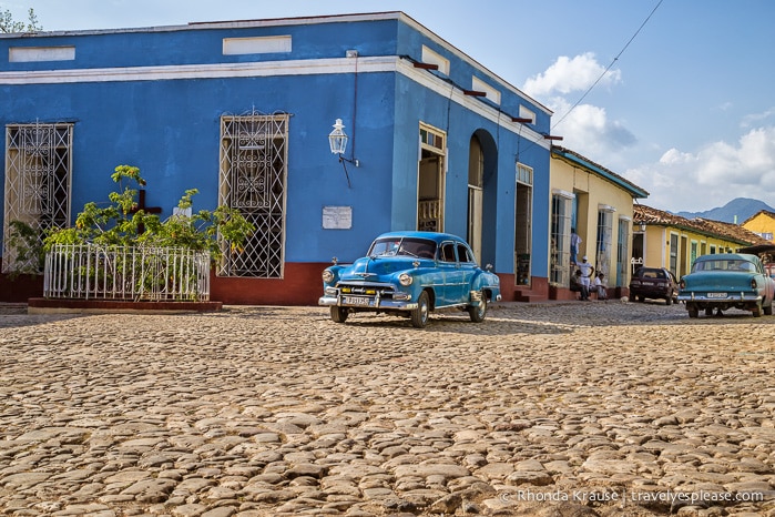 American classic car on a cobblestone street in Trinidad.
