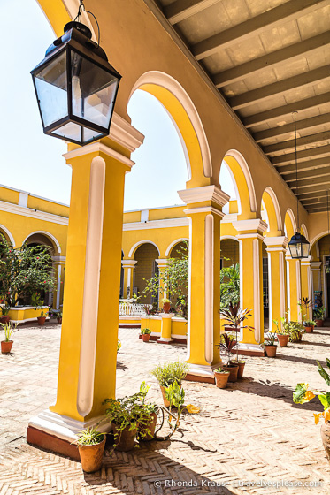 Courtyard framed by yellow arches.