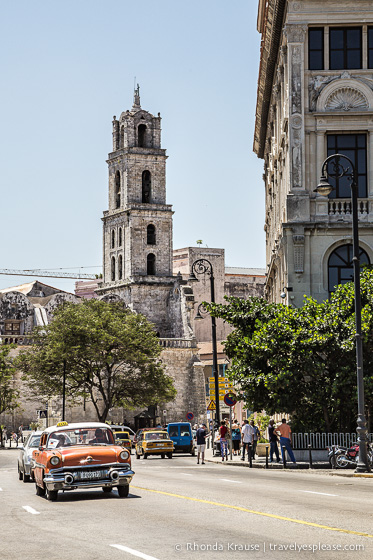 Road with old buildings and a classic car.