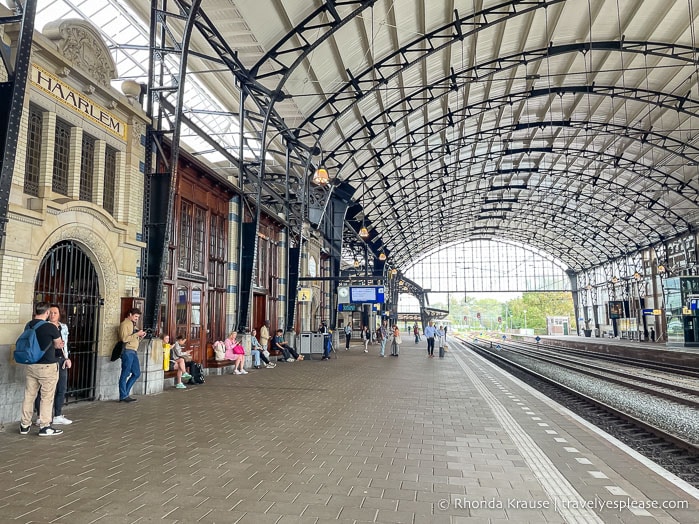 People waiting beside the tracks at the Haarlem train station.